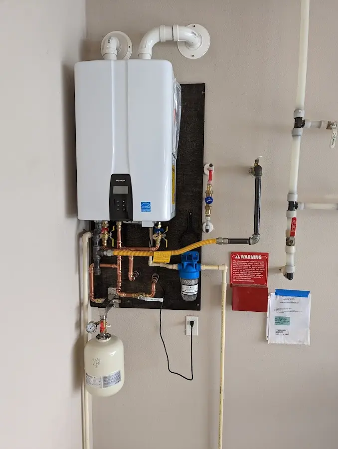 Professional plumber installing copper piping in a Mims home